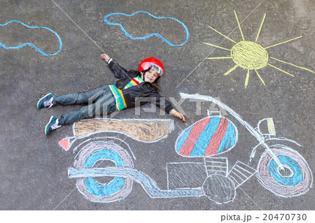 Little kid boy in helmet with motorcycle chalk 20470730