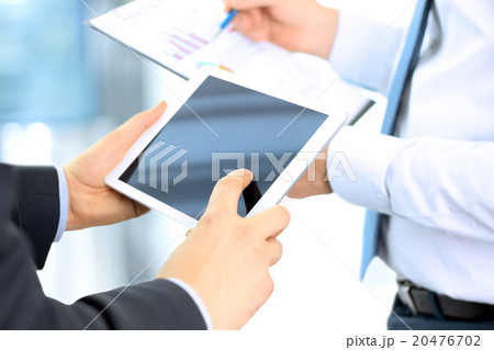 Business colleagues working together and analyzing Business colleagues working together and analyzing 20476702