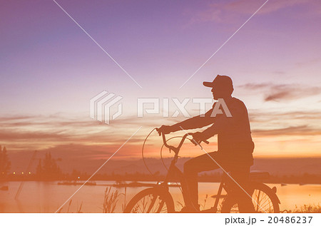 Cycler silhouette in sunrise against sun set  20486237