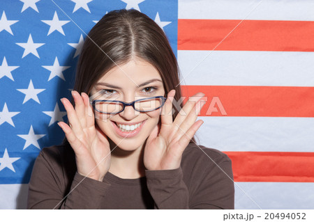 Cheerful intelligent woman near the usa flag 20494052