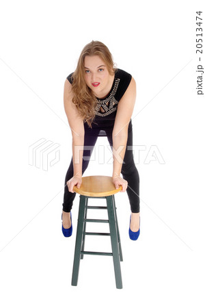 Woman bending forward on chaiD1:K48r. 20513474