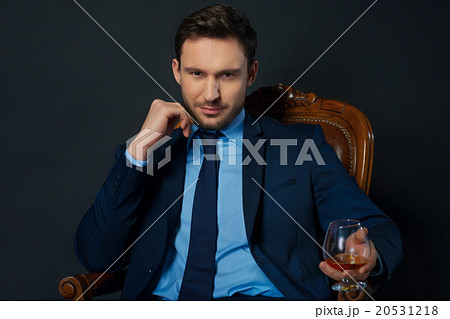 Handsome businessman drinking alcohol  20531218