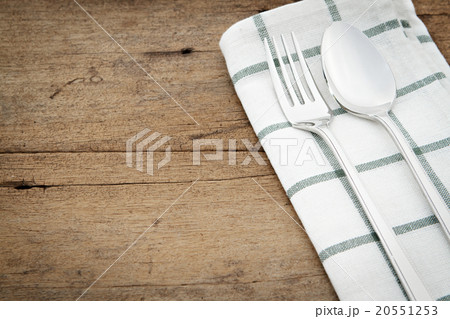 Silverware and napery on wooden background. 20551253