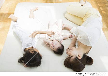 寝転ぶお母さんと赤ちゃんと女の子 寝転ぶお母さんと赤ちゃんと女の子 20552922