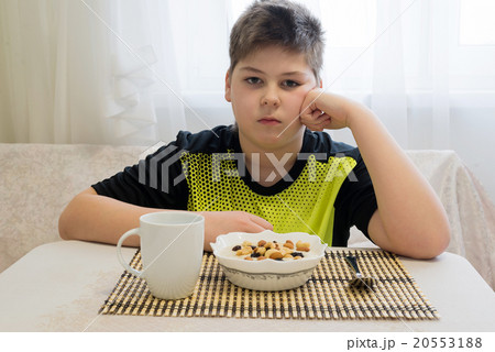 Teenager boy has oatmeal for breakfast 20553188