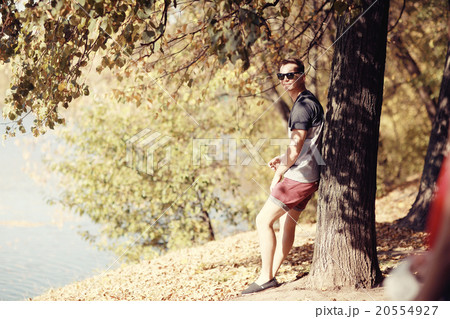 young man in autumn park young man in autumn park 20554927