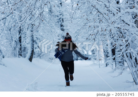 Girl running in winter park snow vacation Girl running in winter park snow vacation 20555745