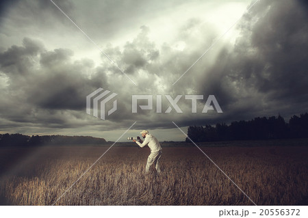 photographer with a camera in the bad weather the storm photographer with a camera in the bad weather the storm 20556372