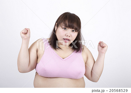 A fat young woman looking at the camera looking - Stock Photo