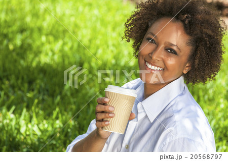 African American Woman Drinking Coffee Outside African American Woman Drinking Coffee Outside 20568797