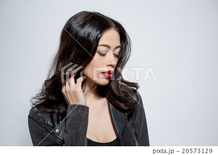 Fashion model woman with dark red lips in studio 20573129