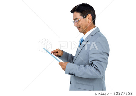 Businessman using his tablet Businessman using his tablet 20577258