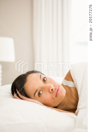 Attractive brunette on bed 20577276