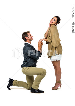 Man proposing woman while kneeling and holding hands 20577605
