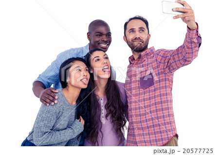 Multi-ethnic friends making face while taking selfie 20577725