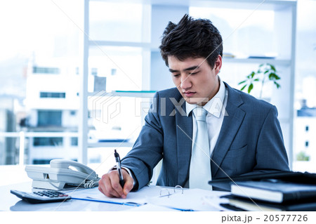 Concentrated asian businessman Concentrated asian businessman 20577726