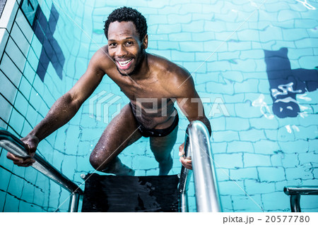 Smiling man getting out the pool Smiling man getting out the pool 20577780