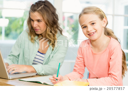 Mother and daughter working Mother and daughter working 20577857