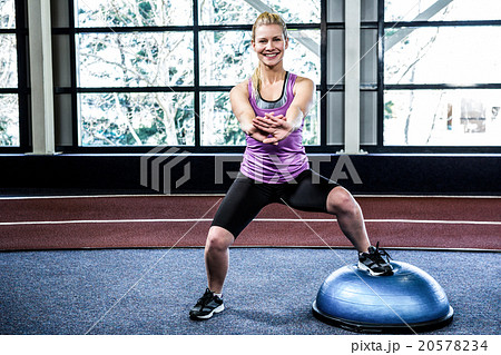 Fit woman doing exercise with bosu ball 20578234