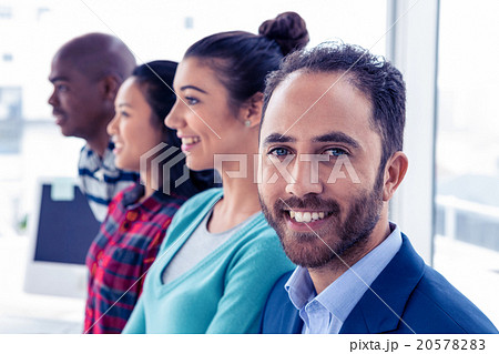 Portrait of young businessman with colleagues 20578283