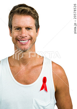 Smiling man wearing aids ribbon on vest Smiling man wearing aids ribbon on vest 20578526