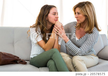 Mother comforting her daughter Mother comforting her daughter 20578575