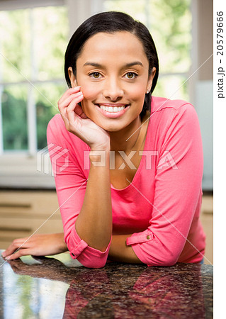 Portrait of smiling brunette in kitchen Portrait of smiling brunette in kitchen 20579666