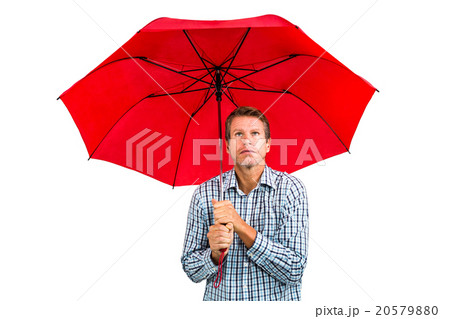 Scared man looking up while holding red umbrella Scared man looking up while holding red umbrella 20579880