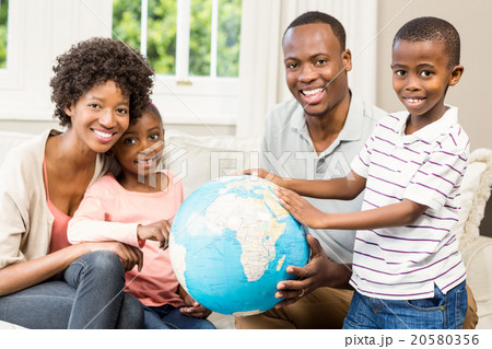 Smiling family sitting on the couch together 20580356