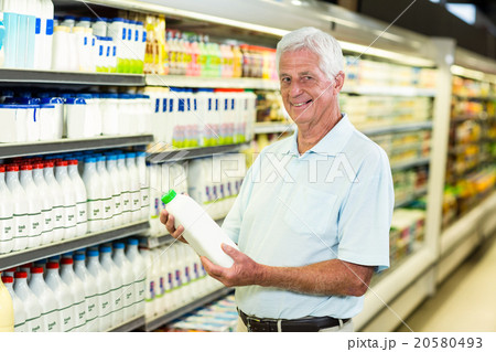Senior man buying milk 20580493