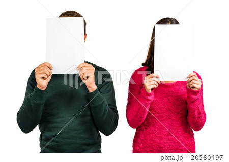 Couple hiding faces with documents 20580497