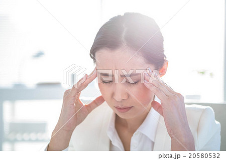 Stressed businesswoman working at her desk Stressed businesswoman working at her desk 20580532