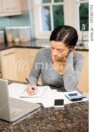 Worried brunette counting bills 20580705