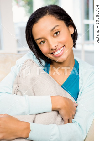 Portrait of attractive brunette on the sofa 20580764