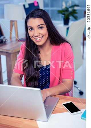 smiling businesswoman working in creative office smiling businesswoman working in creative office 20581645