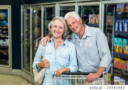 Smiling senior couple with cart Smiling senior couple with cart 20581981