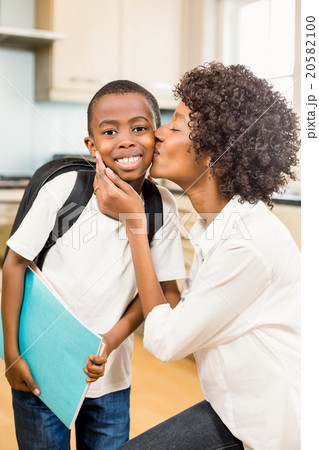 Mother kissing son in the kitchen Mother kissing son in the kitchen 20582100