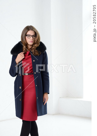 Girl in coat posing at studio Girl in coat posing at studio 20582705