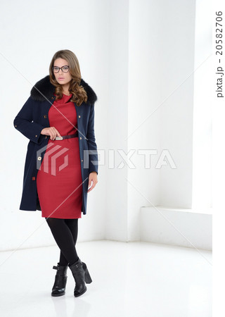 Girl in coat posing at studio Girl in coat posing at studio 20582706