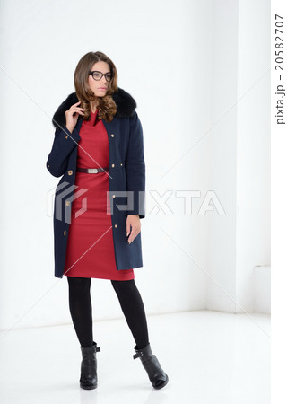 Girl in coat posing at studio Girl in coat posing at studio 20582707