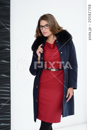 Girl in coat posing at studio 20582708
