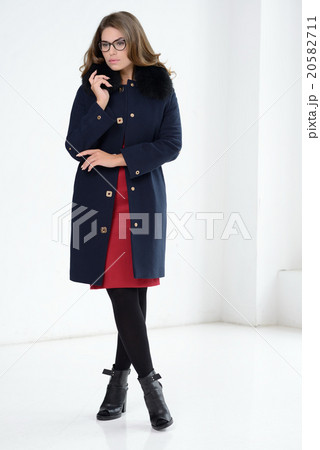 Girl in coat posing at studio 20582711