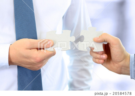 Businessmen Hand Connecting Jigsaw Puzzle Businessmen Hand Connecting Jigsaw Puzzle 20584578