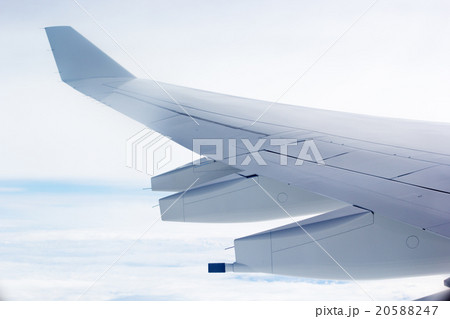 Wing of an airplane flying above the clouds 20588247