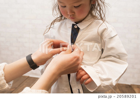 シャツのボタンを留める親子 20589201