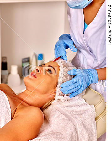 Woman middle-aged in spa salon with beautician 20594362