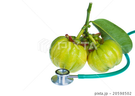 Close up garcinia cambogia and stethoscope on white background. 20598502