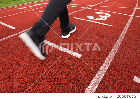 Red running racetrack on the stadium with run legs 20598655