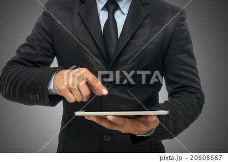 Businessman using the tablet on gray background, include clippin Businessman using the tablet on gray background, include clippin 20608687