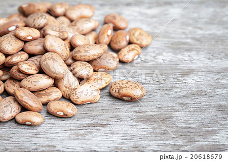 Pinto beans pile on wooden background. 20618679